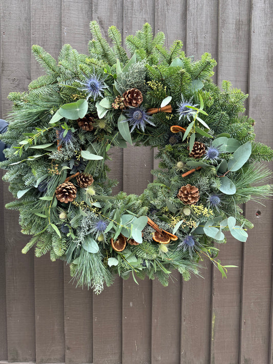 Sea Holly and Pine Christmas Wreath with eucalyptus, spruce, and natural accents – handmade by Barns Florals in Cornwall.